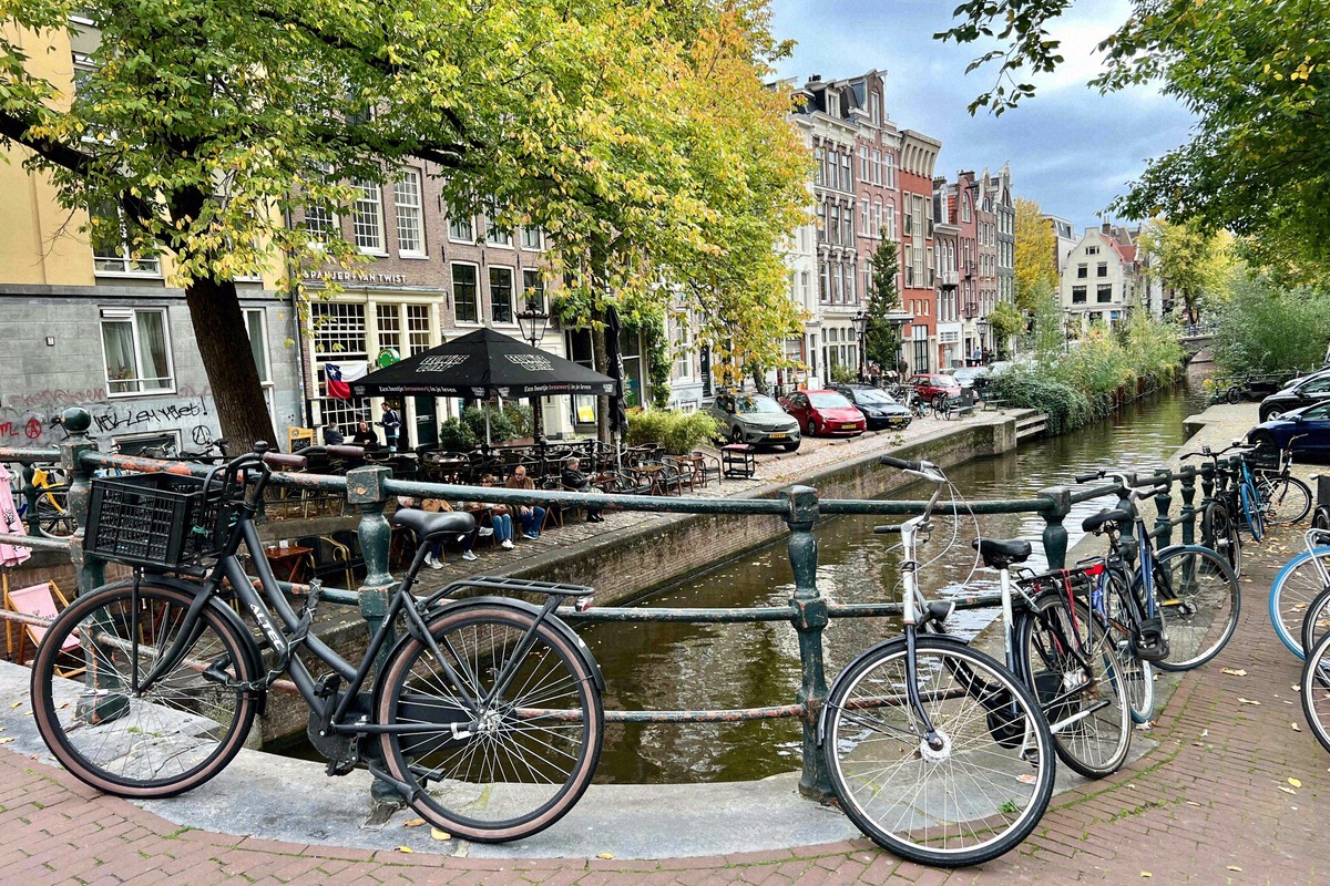 Canal panorama in the Jordaan with bicycles parked along the railing