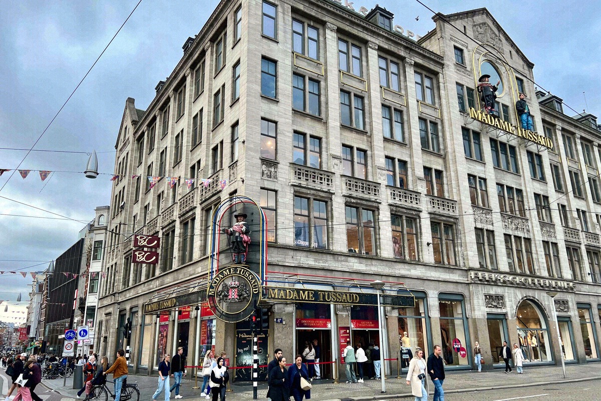 Madame Tussauds building on Dam Square with colorful figures on the facade