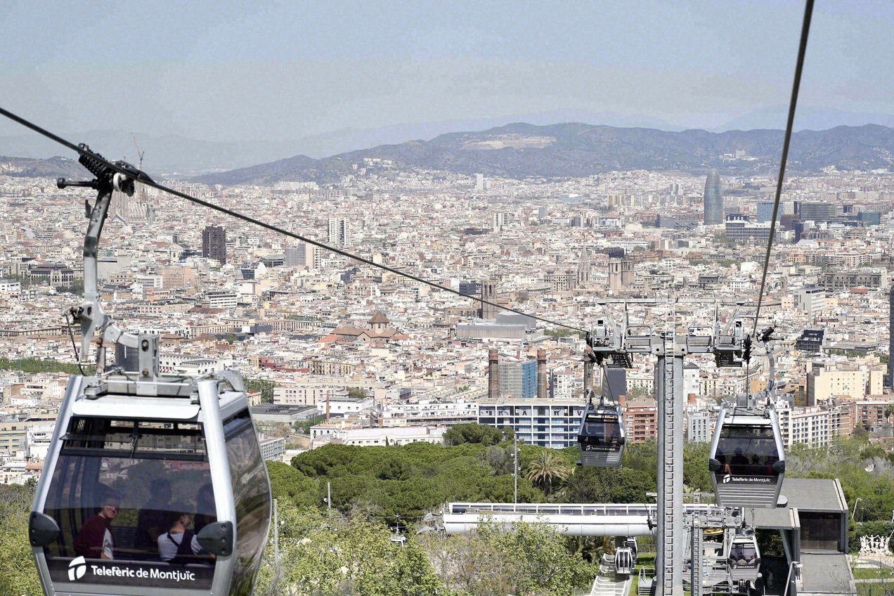 Cable cars of the Telefèric de Montjuïc above the panorama of Barcelona