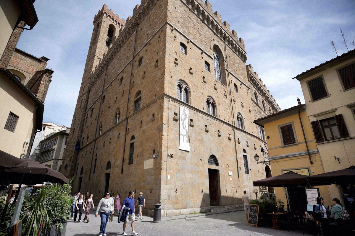 Massive rusticated facade of the Palazzo del Bargello with visitors outside