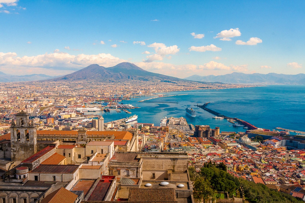 City panorama of Naples with the harbor, Castel Nuovo and Vesuvius above the bay