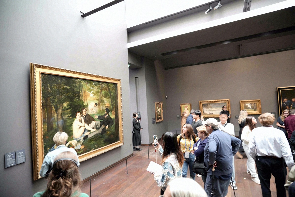 Visiteurs devant Le Déjeuner sur l'herbe de Manet au musée d'Orsay