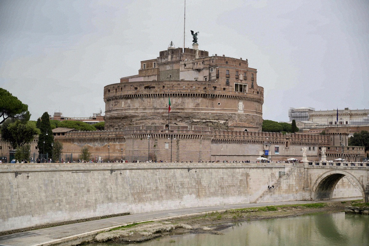 Castel Sant'Angelo from the banks of the Tiber, with the bronze statue of the Archangel Michael on its roof