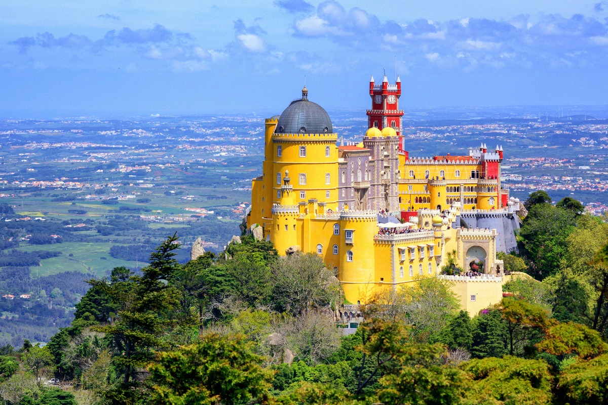 The Palácio Nacional da Pena with its yellow and red wings above the wooded Serra de Sintra