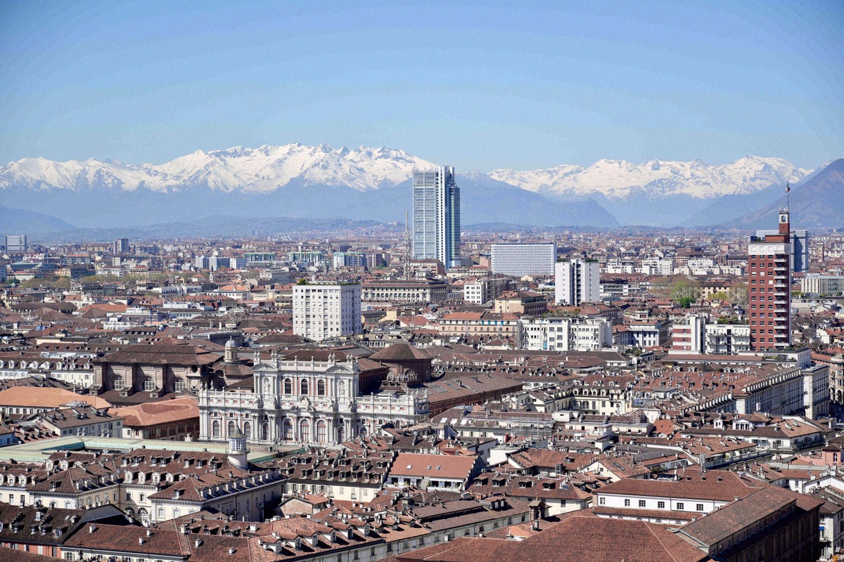 Wide view over Turin's old town with the Palazzo Carignano and the snow-capped Alps