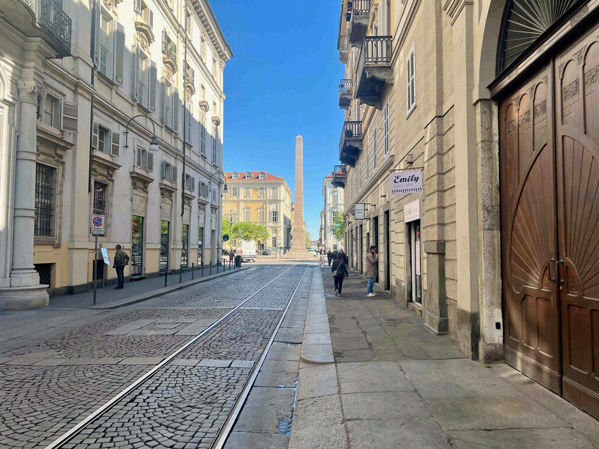 View along Via Garibaldi with tram tracks leading to the obelisk on Piazza Statuto