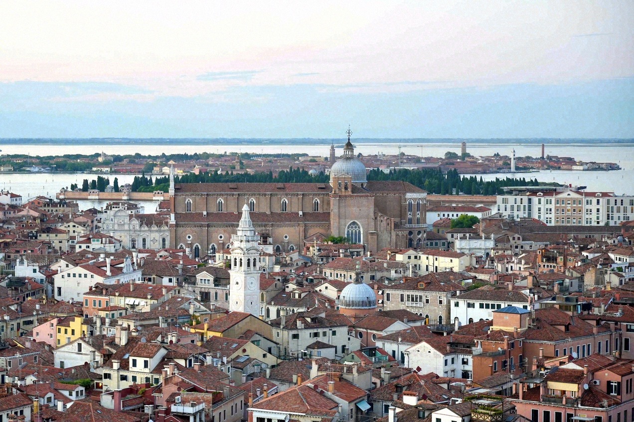 Panorama over the rooftops of Venice with the Gothic Basilica dei Santi Giovanni e Paolo and the lagoon